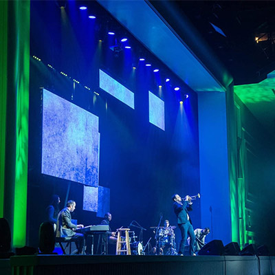 Modern Warrior performance on stage with multimedia screens at Natcon